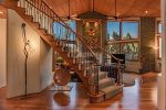 A stunning curved staircase leads to the upper level of the home